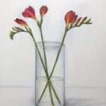 Red Freesias in glass vase